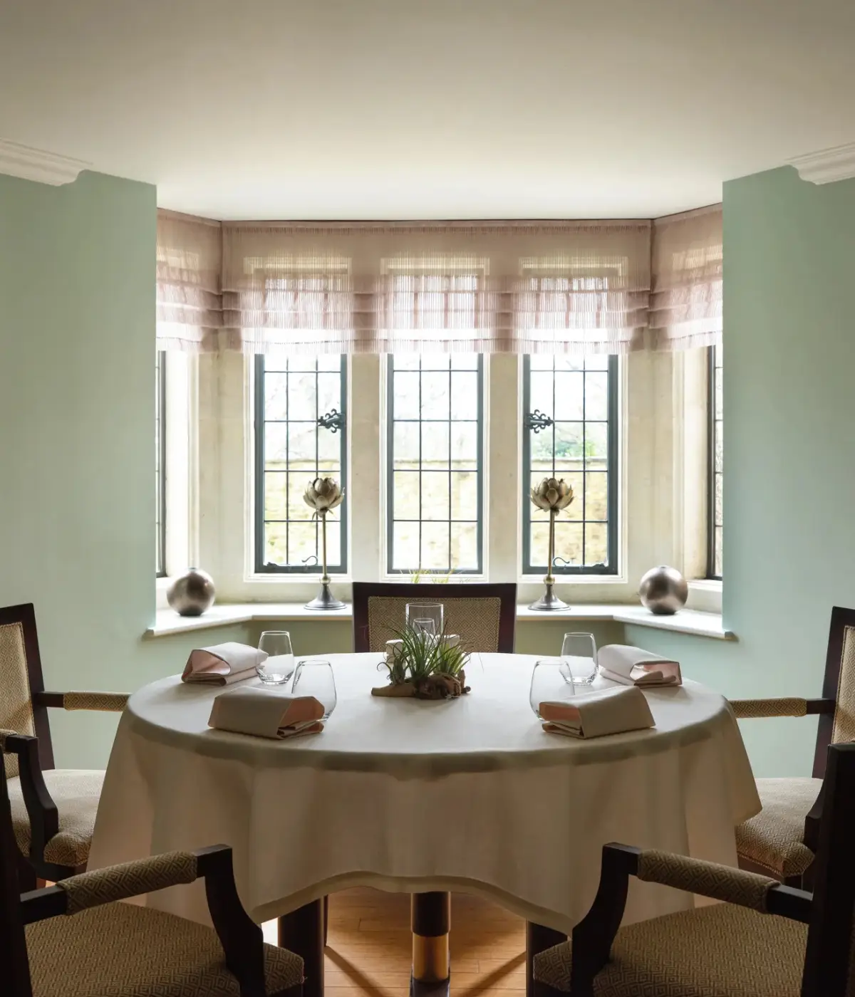 Dining room with a round table at Whatley Manor