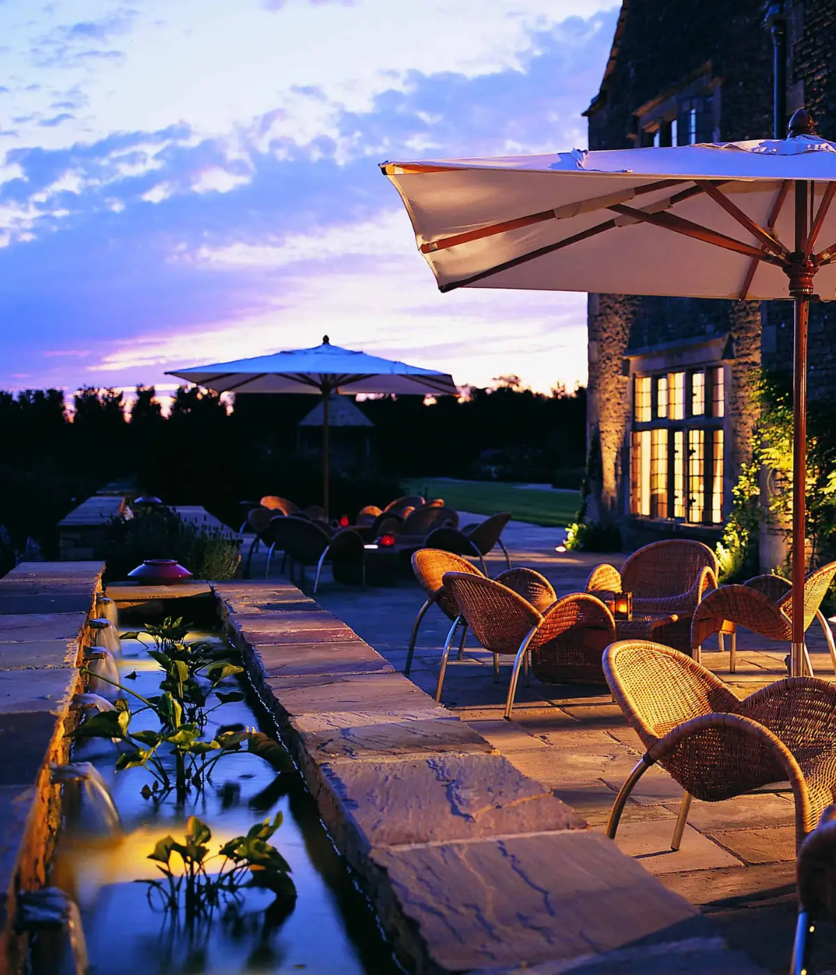 Terrace with parasols at dusk at Whatley Manor