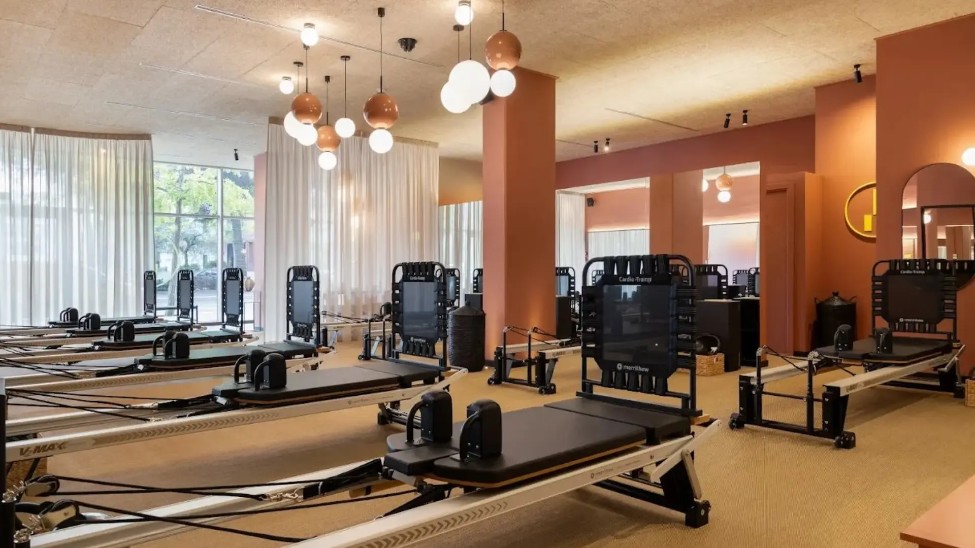 Prescription studio with chandeliers and Pilates reformers